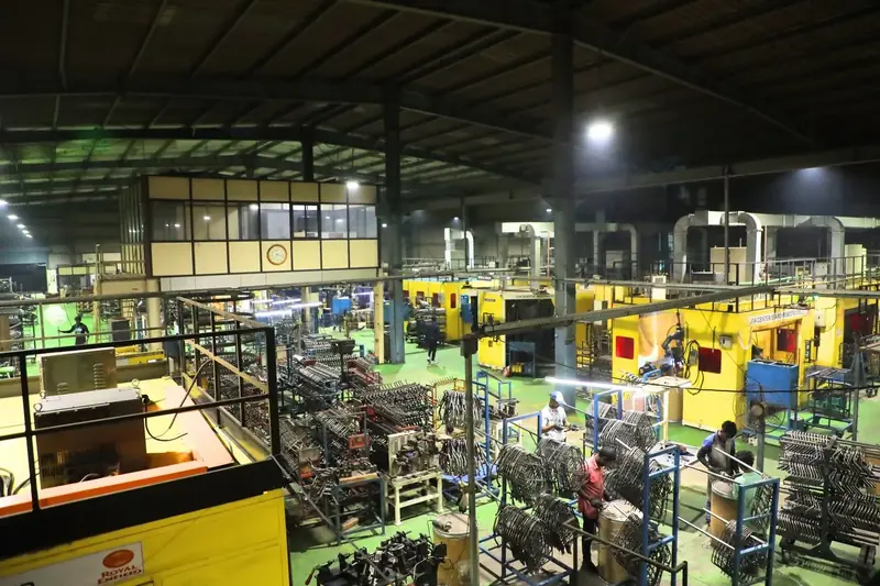 Wide view of the AR Automotive weld shop with yellow welding machines